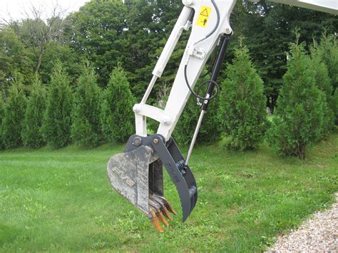 mini excavator with main pin thumb|thumb attachment for small backhoe.